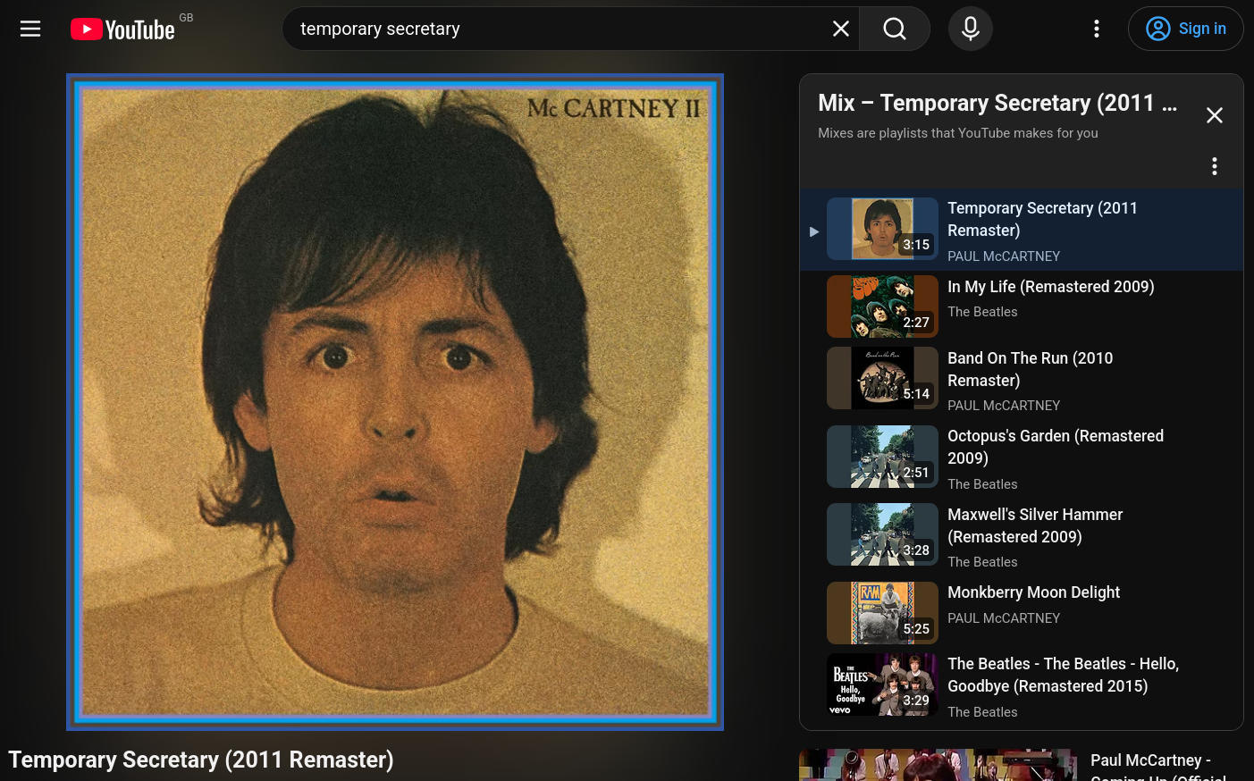 A screenshot of YouTube on a computer. The video playing is that of Paul McCartney's 'Temporary Secretary', showing the 'McCartney II' album cover featuring his face. To the right of the video, is a playlist of related songs, mostly tracks from The Beatles.
